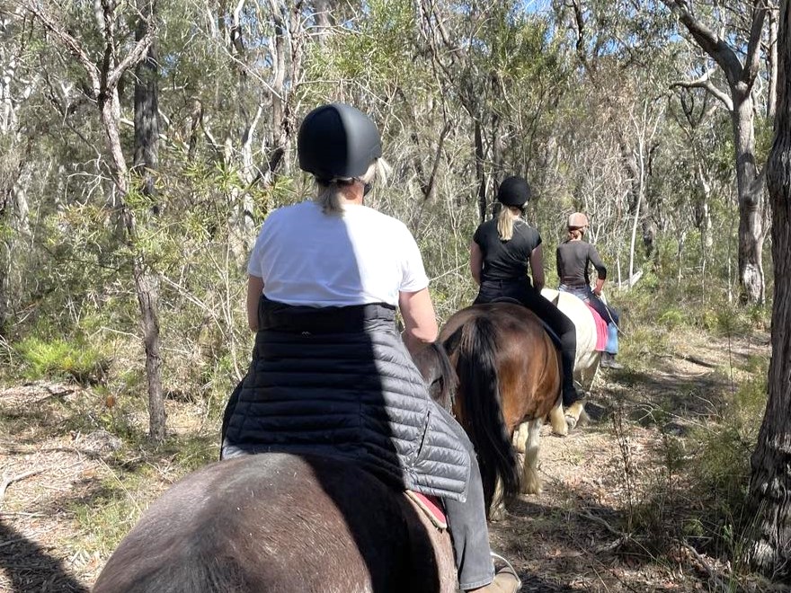 women horse riding in australian bush